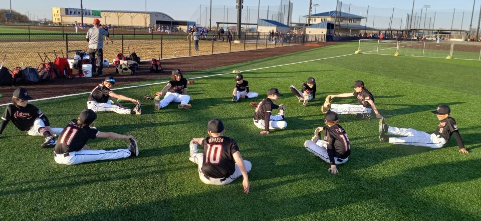 11/12U Astros stretching before the game