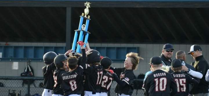 11/12 Astros rush field with Championship trophy