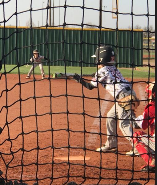 Eli #35 batting and Malcolm the base runner on 1st