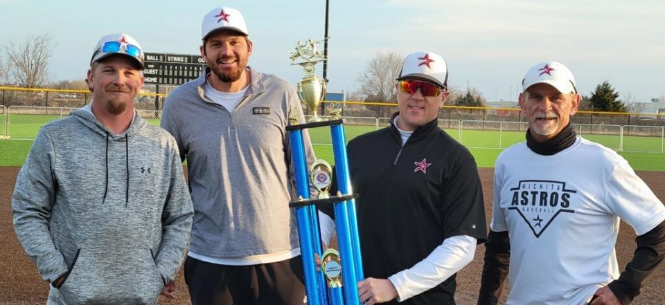 11/12U Astro coaches hold championship trophy