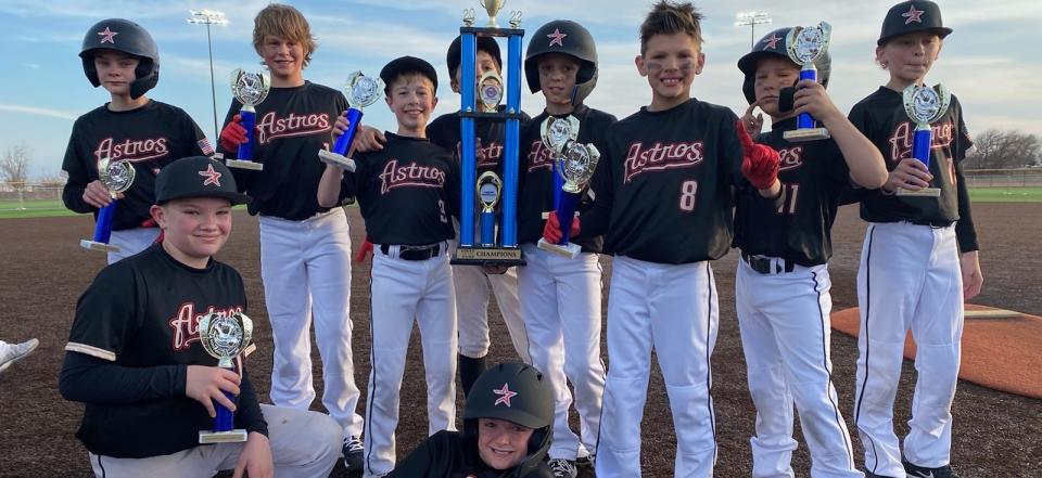 11/12U Astros on the field with Championship trophies